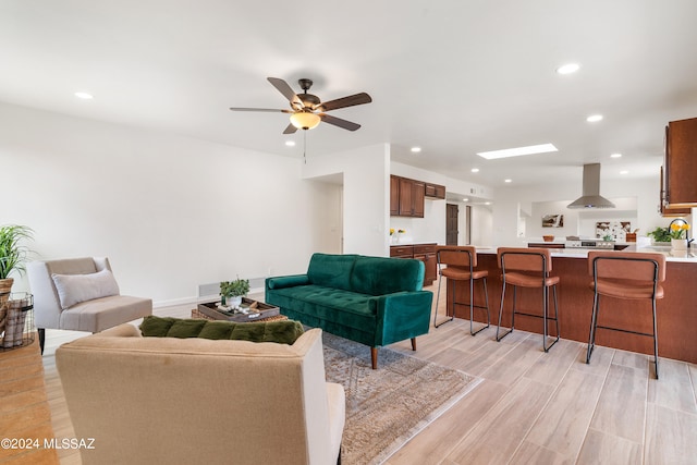 living room featuring light wood-style floors, ceiling fan, recessed lighting, and visible vents