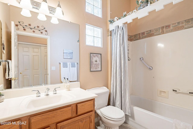 bathroom featuring vanity, shower / tub combo, and toilet