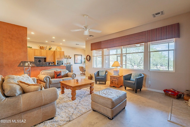 living area featuring a wealth of natural light, a ceiling fan, recessed lighting, and visible vents
