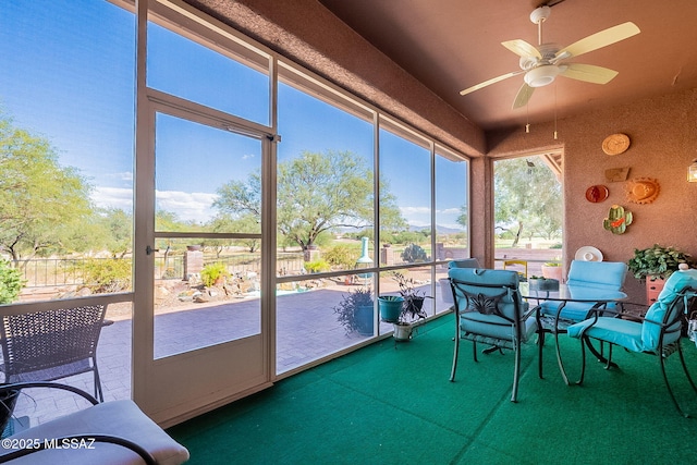 sunroom with a ceiling fan
