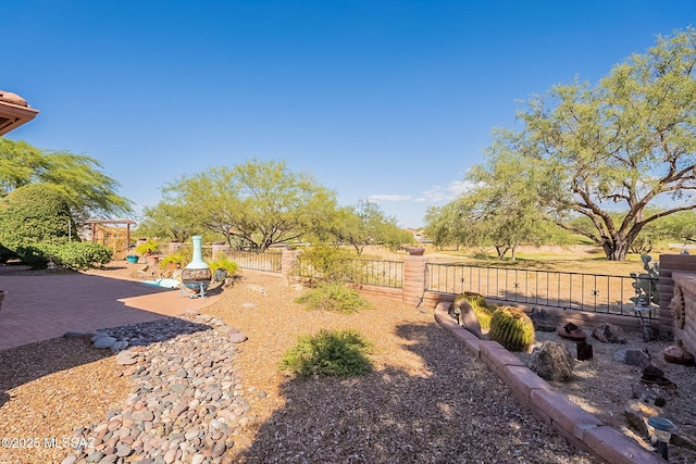 view of yard with fence and a patio area