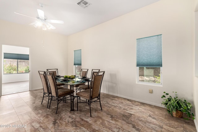 dining space featuring baseboards, a ceiling fan, and visible vents