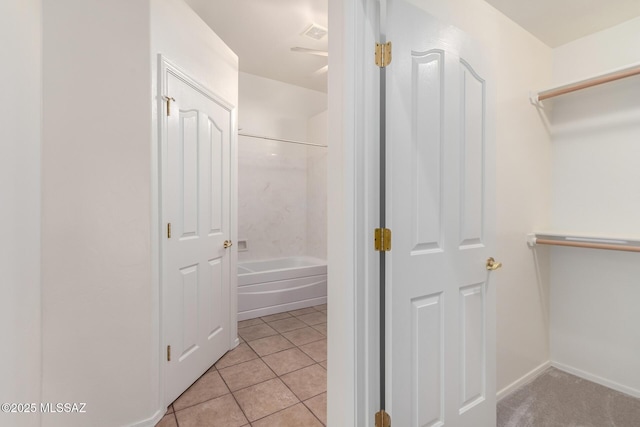 interior space with tile patterned flooring, bathtub / shower combination, and visible vents