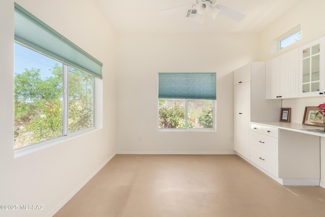 interior space featuring visible vents, glass insert cabinets, light countertops, white cabinetry, and a ceiling fan