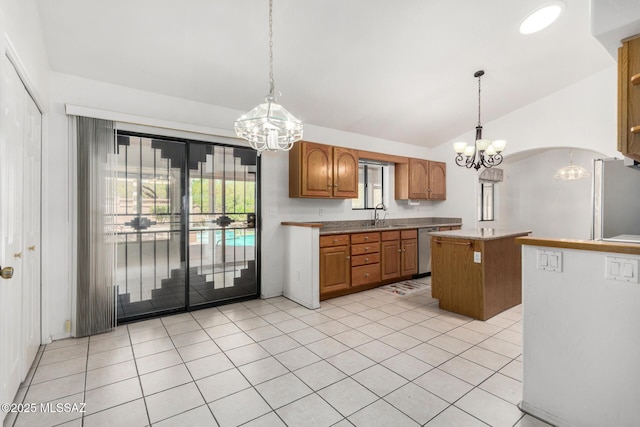 kitchen with a center island, stainless steel appliances, a chandelier, and a sink