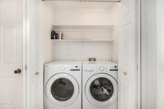 laundry area featuring separate washer and dryer and laundry area