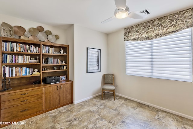 60333 E Ankole Dr, Oracle, AZ 85623 - sitting room with ceiling fan, plenty of natural light, and stone finish floors
