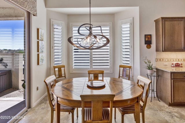 60333 E Ankole Dr, Oracle, AZ 85623 - dining room featuring a chandelier and light stone finish flooring