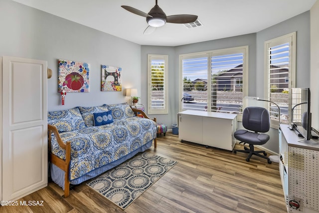 60333 E Ankole Dr, Oracle, AZ 85623 - bedroom featuring wood finished floors, a ceiling fan, and a desk