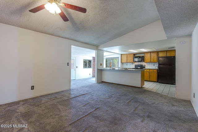 unfurnished living room featuring a textured ceiling, light colored carpet, ceiling fan, and vaulted ceiling