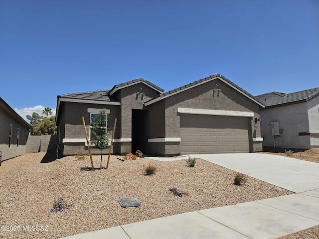 9817 E Gray Hawk Dr, Tucson, AZ 85730 - single story home featuring a tiled roof, an attached garage, driveway, and stucco siding