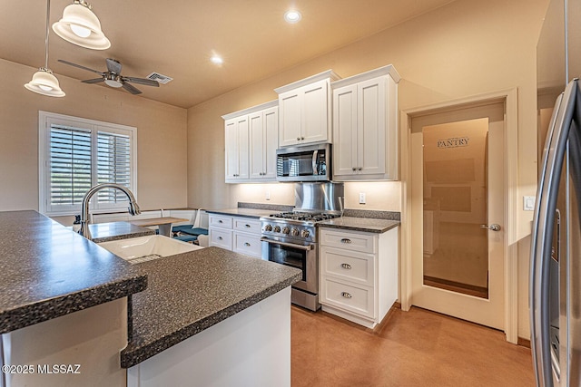 kitchen featuring a ceiling fan, visible vents, a sink, stainless steel appliances, and white cabinetry