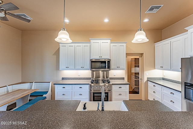 kitchen with a ceiling fan, visible vents, pendant lighting, appliances with stainless steel finishes, and white cabinetry