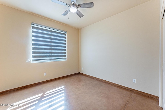 spare room featuring baseboards and ceiling fan