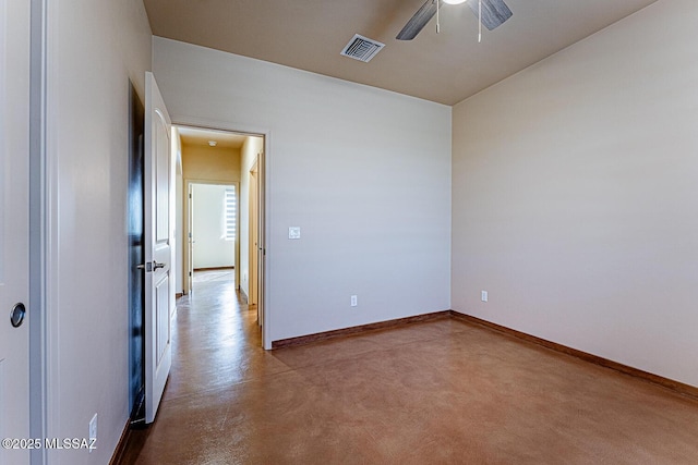unfurnished room with ceiling fan, visible vents, concrete floors, and baseboards