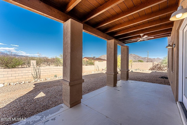 view of patio / terrace featuring a fenced backyard and a mountain view