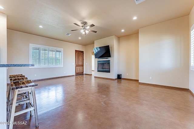 unfurnished living room featuring baseboards, a ceiling fan, finished concrete floors, and recessed lighting