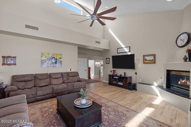 14171 N Gibson Trl, Tucson, AZ 85755 - living area featuring ceiling fan, wood finished floors, high vaulted ceiling, and a fireplace