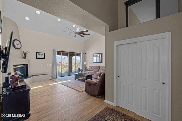 14171 N Gibson Trl, Tucson, AZ 85755 - living area with a ceiling fan, a fireplace, high vaulted ceiling, wood finished floors, and recessed lighting
