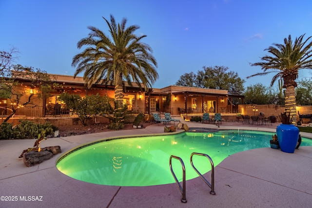 outdoor pool with a patio area