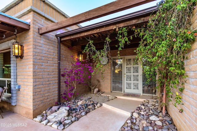 property entrance featuring brick siding