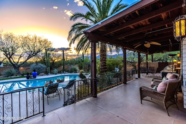 exterior space featuring a patio, a ceiling fan, a fenced backyard, and a fenced in pool