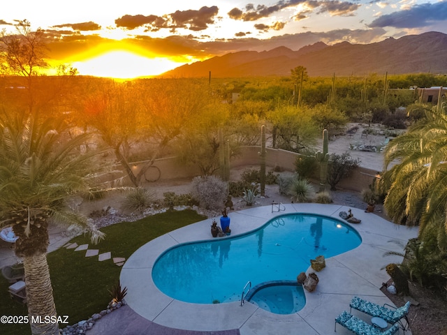 view of swimming pool with a fenced in pool, a fenced backyard, a patio area, and a mountain view