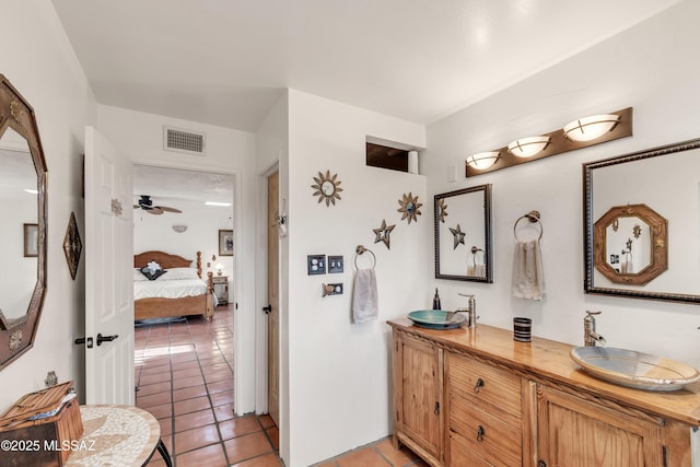 bathroom featuring a sink, double vanity, tile patterned floors, ensuite bathroom, and visible vents