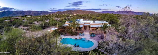 birds eye view of property with a mountain view
