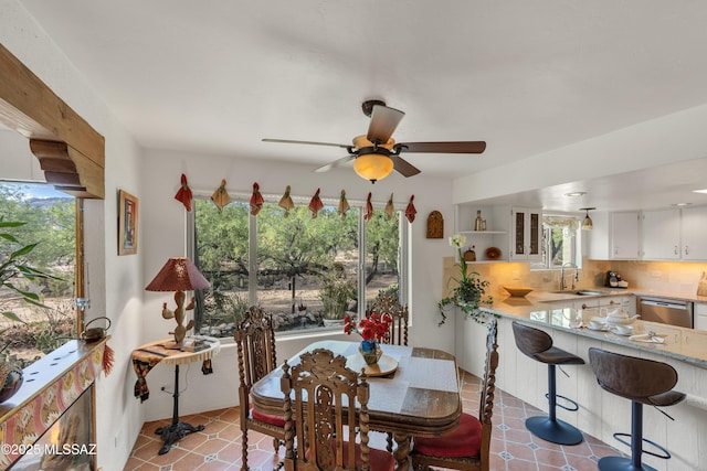 dining room featuring a ceiling fan, tile patterned floors, and plenty of natural light