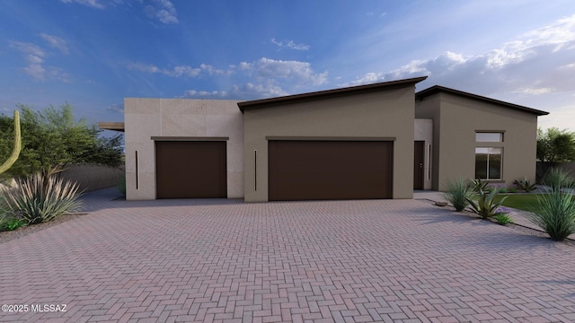 242 E Placita Haciendas Del Lago, Sahuarita, AZ 85629 - modern home featuring stucco siding, an attached garage, and decorative driveway