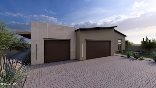 242 E Placita Haciendas Del Lago, Sahuarita, AZ 85629 - garage featuring decorative driveway