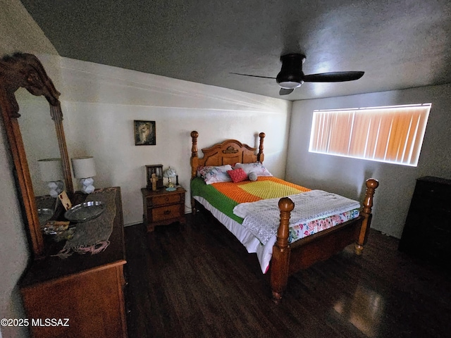 bedroom with a textured ceiling, ceiling fan, and wood finished floors