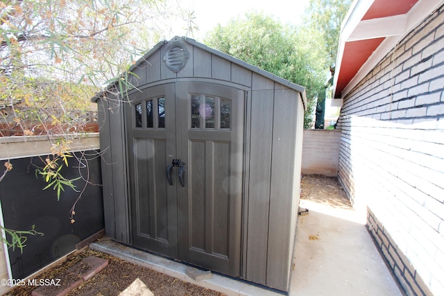 view of shed featuring fence