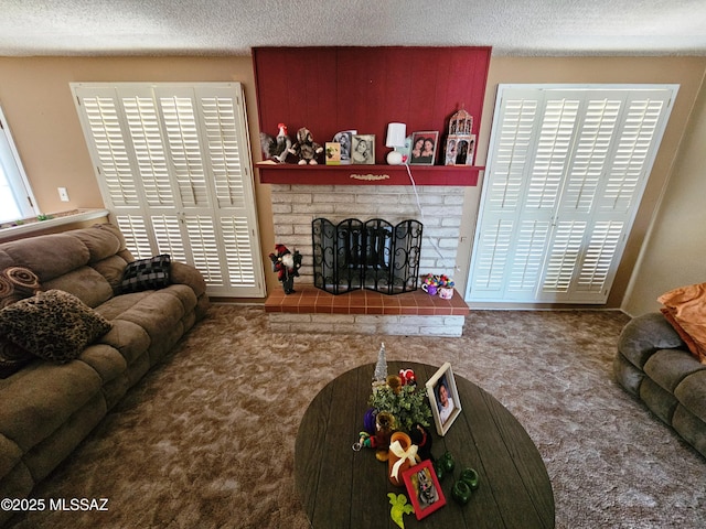 carpeted living area featuring a textured ceiling and a fireplace