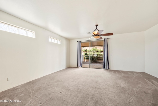 spare room featuring carpet and a ceiling fan