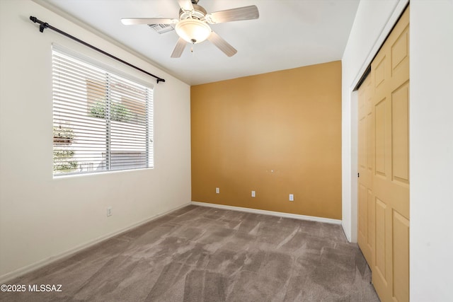 unfurnished bedroom featuring carpet, a closet, baseboards, and visible vents