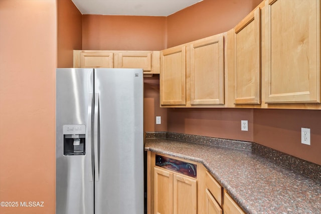 kitchen featuring light brown cabinetry and stainless steel fridge