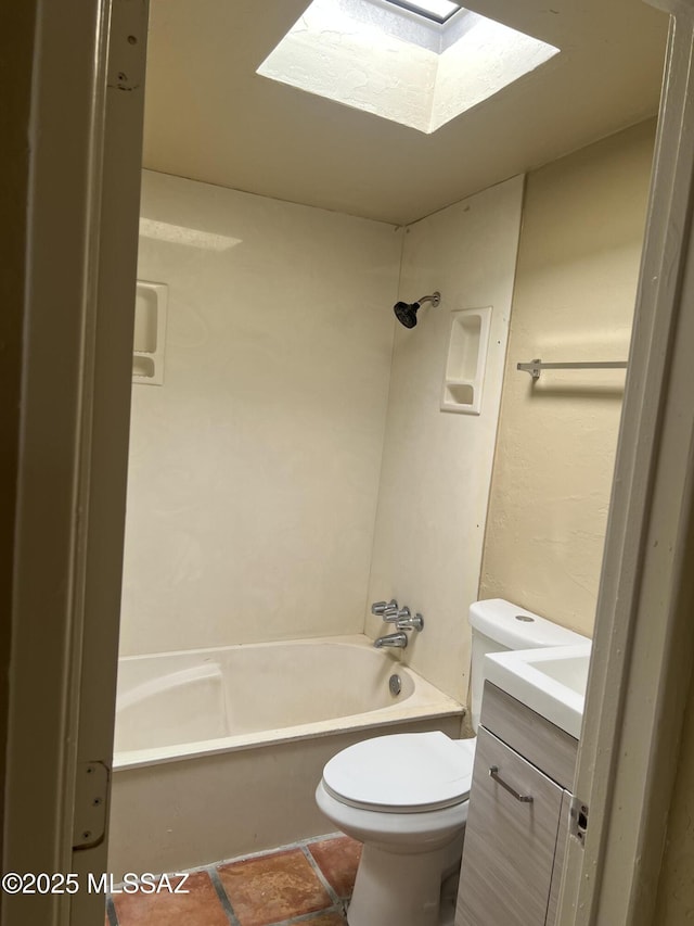 bathroom featuring vanity, a skylight, toilet, and shower / washtub combination