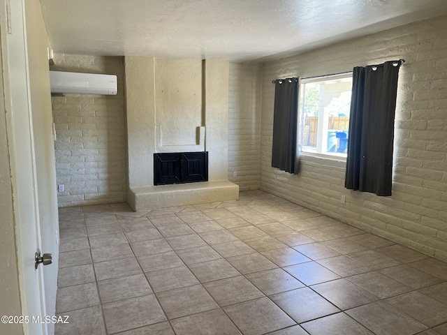 unfurnished living room featuring a fireplace with raised hearth, a wall mounted AC, and tile patterned floors