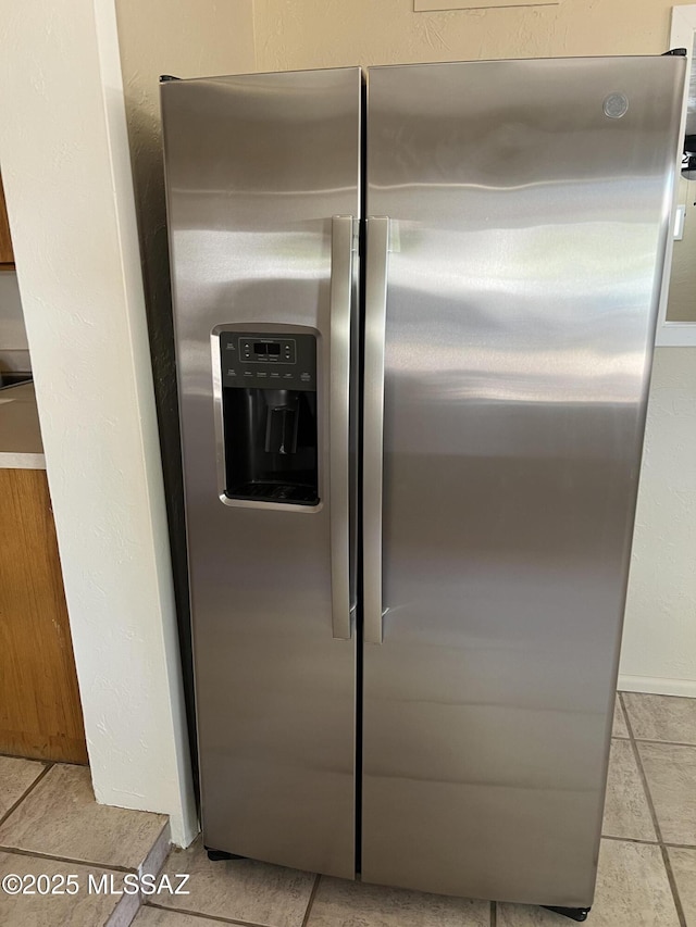 room details featuring stainless steel fridge with ice dispenser
