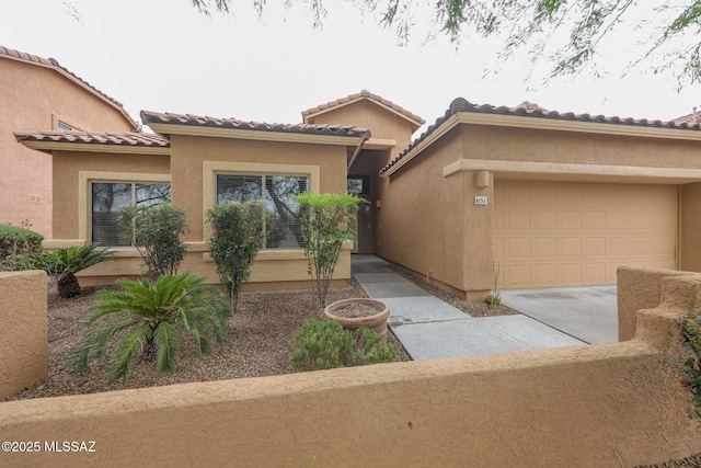 651 W Sonatina Ln, Oro Valley, AZ 85737 - mediterranean / spanish-style home with stucco siding, a garage, concrete driveway, and a tiled roof