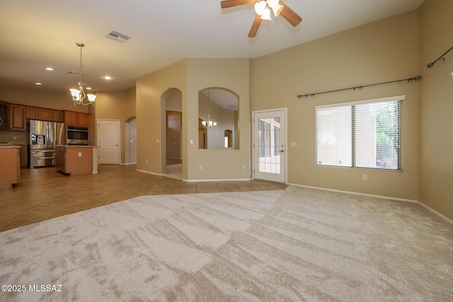 651 W Sonatina Ln, Oro Valley, AZ 85737 - unfurnished living room with arched walkways, a chandelier, ceiling fan, light carpet, and recessed lighting