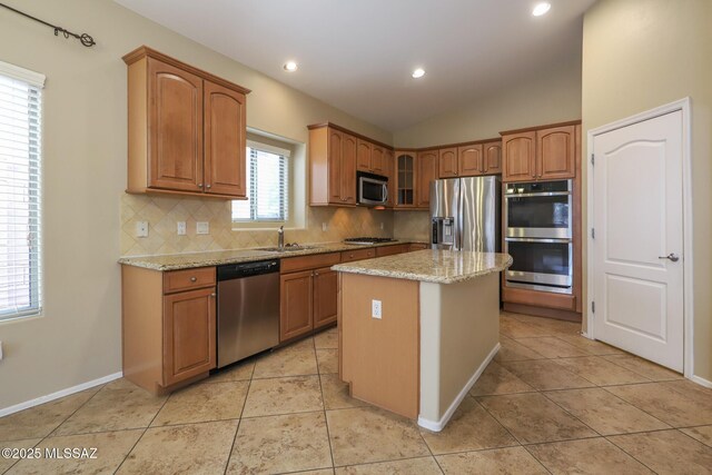651 W Sonatina Ln, Oro Valley, AZ 85737 - kitchen with appliances with stainless steel finishes, tasteful backsplash, light stone countertops, a sink, and recessed lighting