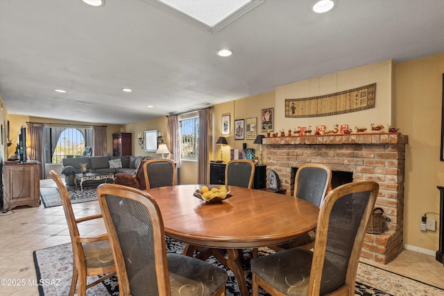 dining space with a brick fireplace, recessed lighting, and light tile patterned floors