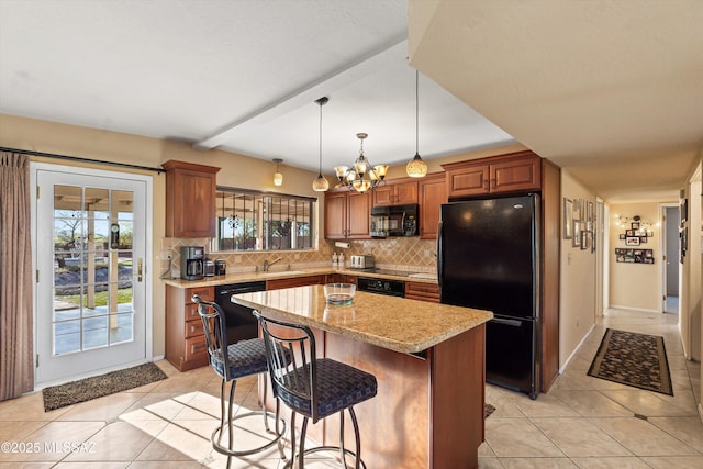 kitchen featuring light tile patterned floors, backsplash, black appliances, and a notable chandelier