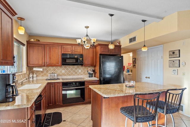kitchen featuring visible vents, tasteful backsplash, light tile patterned floors, a sink, and black appliances
