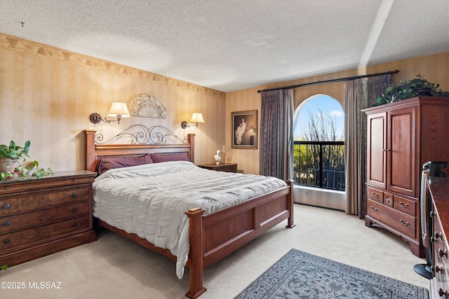 bedroom with a textured ceiling and light carpet