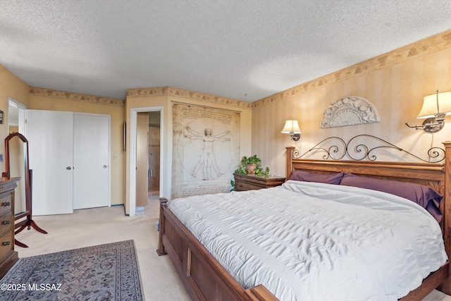 bedroom featuring two closets, a textured ceiling, and light colored carpet