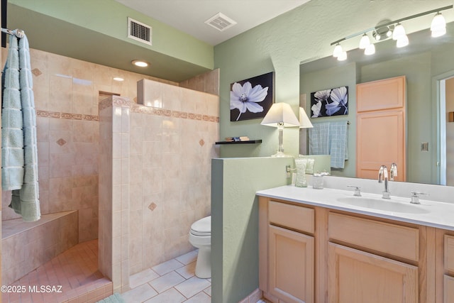 full bathroom featuring tile patterned floors, vanity, toilet, and visible vents